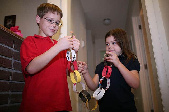 Create Christmas paper chains made out of recycled materials to decorate